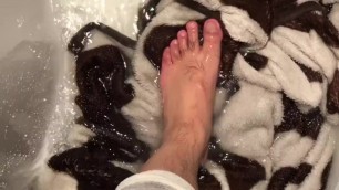 Mature Male Feet Washing a Blanket in Hot Tub