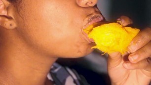 Sexy mouth ebony playing with a mango