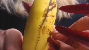 Katiegodess long sharp red nails sctratching banana